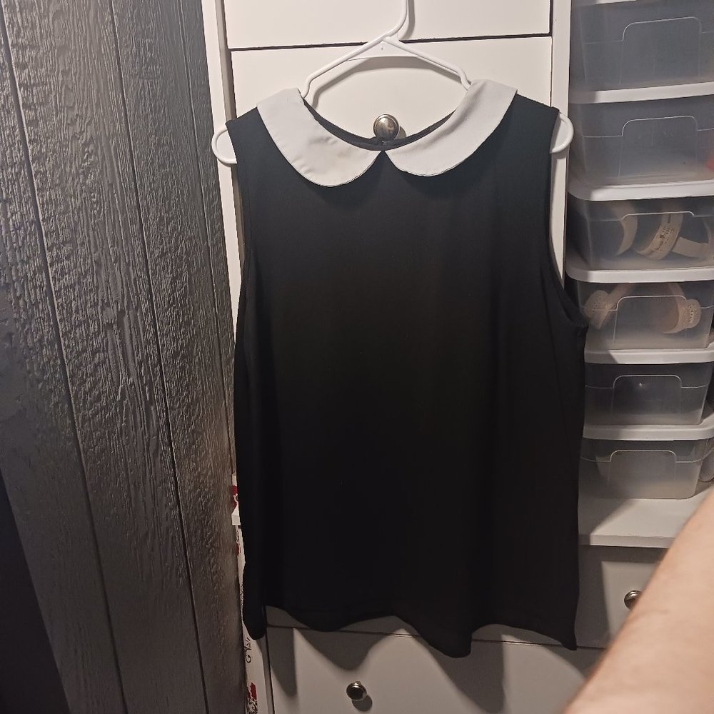 black sleeveless top with white peter pan collar